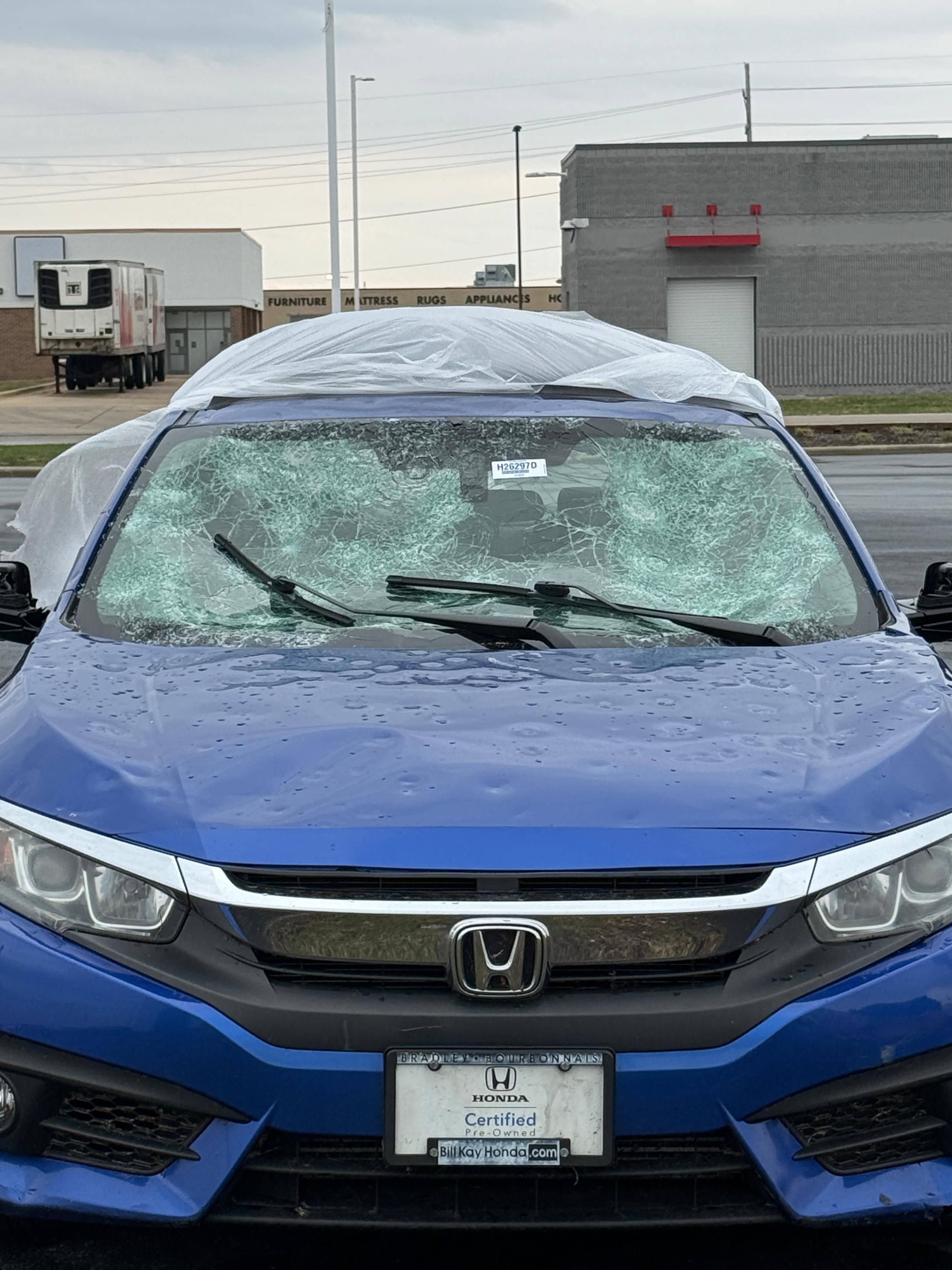 Vehicle hood covered in hail damage — before paintless dent repair